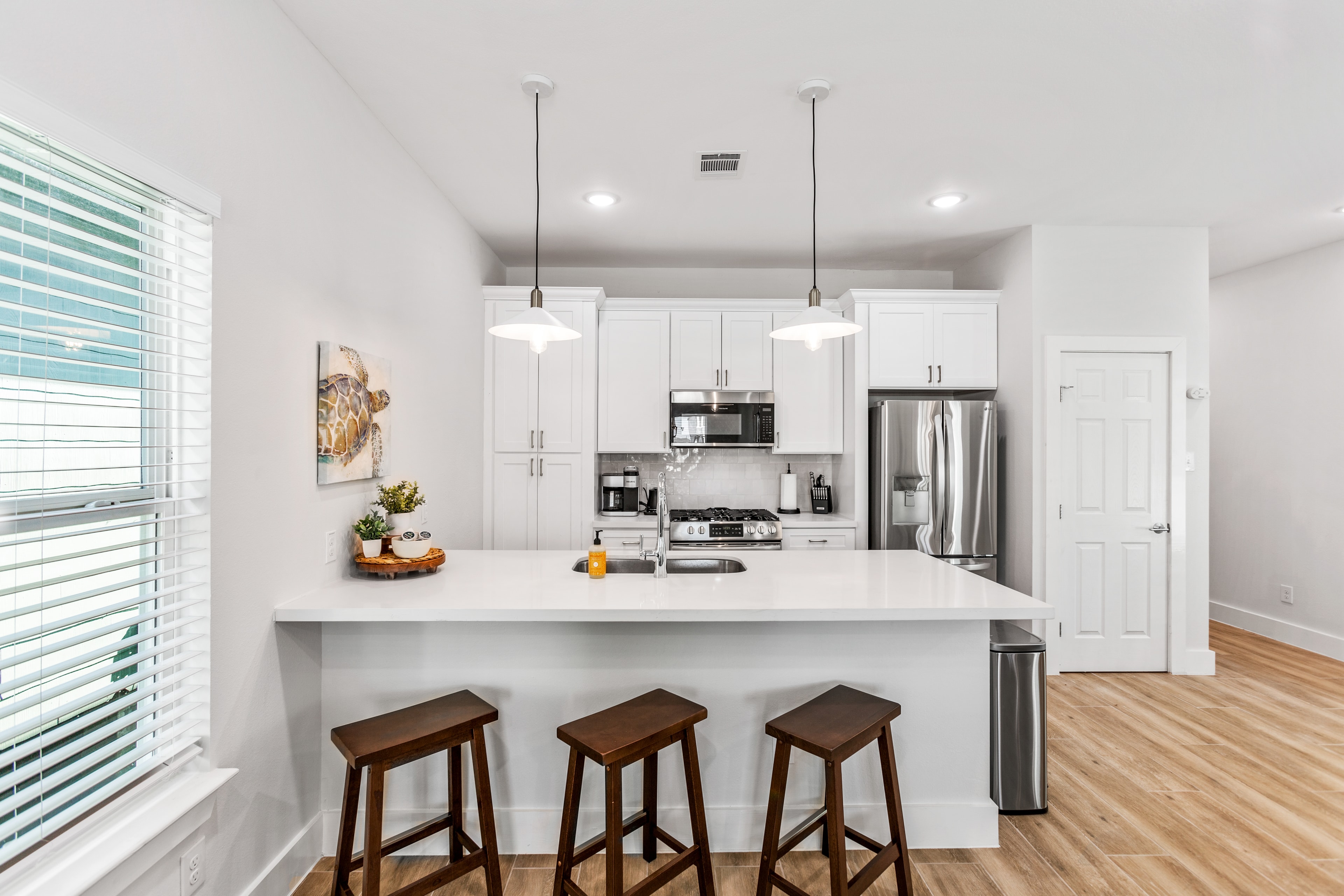 Sea Star Tides — kitchen with island and bar stools