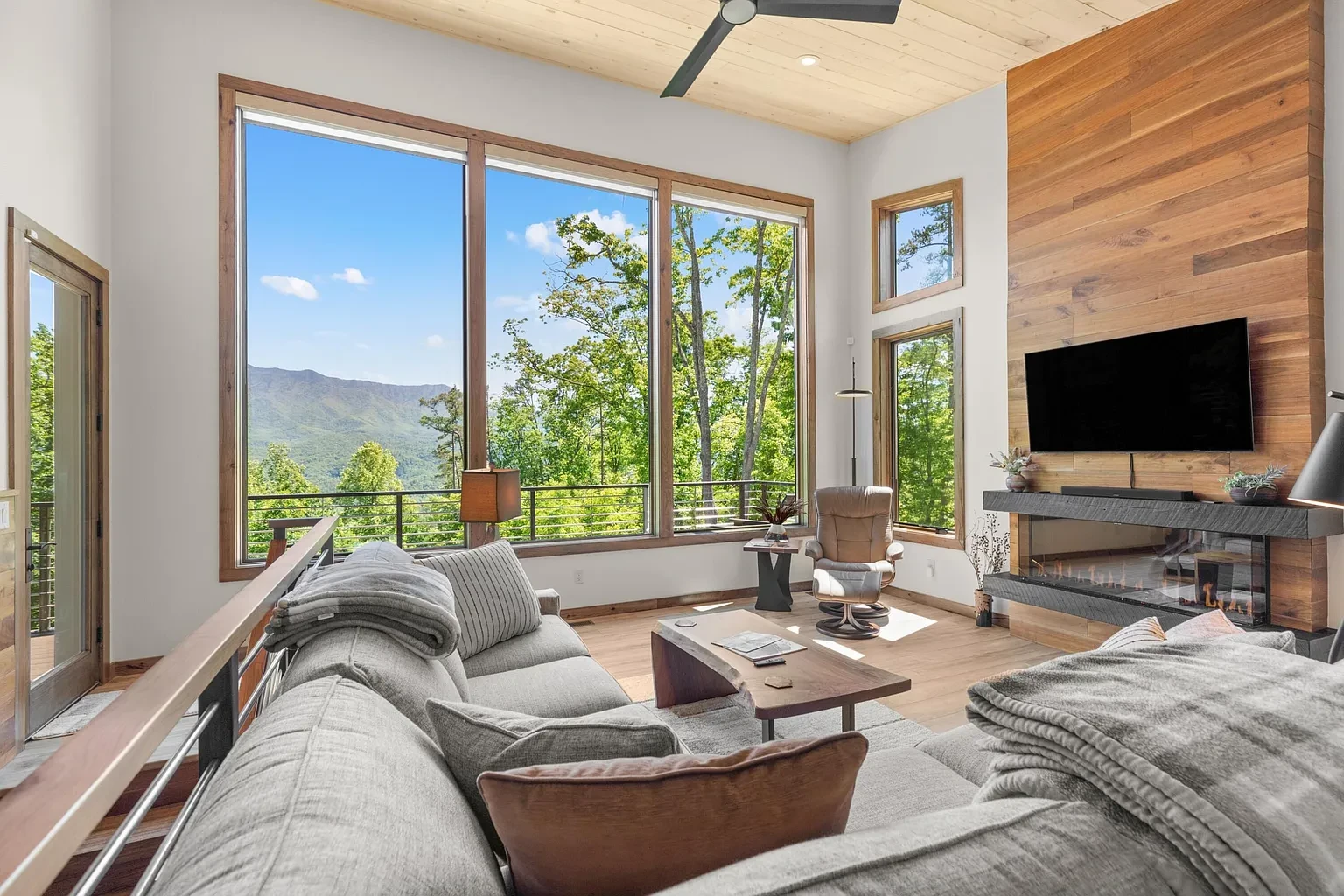 Sunset Ridge Retreat — living room with floor-to-ceiling windows and fireplace