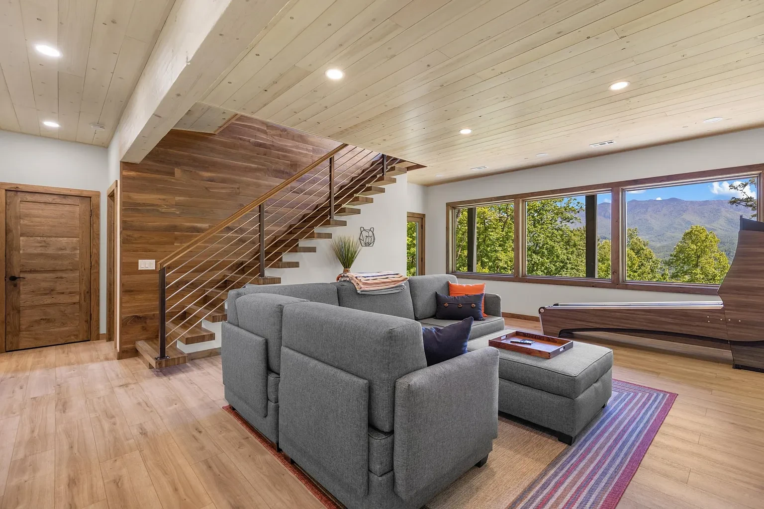 Sunset Ridge Retreat — lower living area with cantilevered staircase